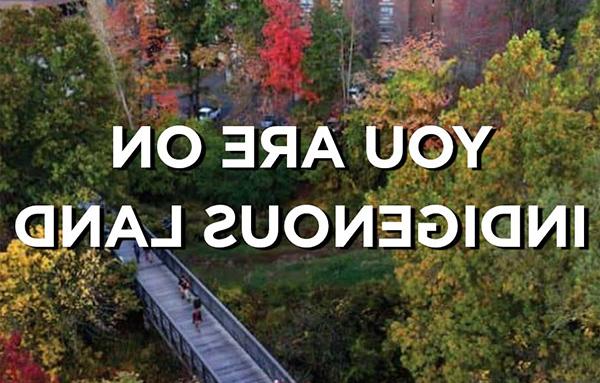 Sky view of campus bridge with words "You are on Indigenous Land"