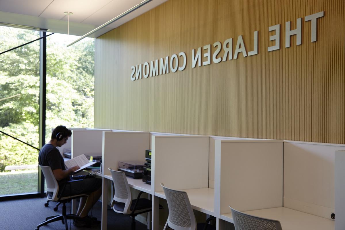 student using a listening station in Allen Library